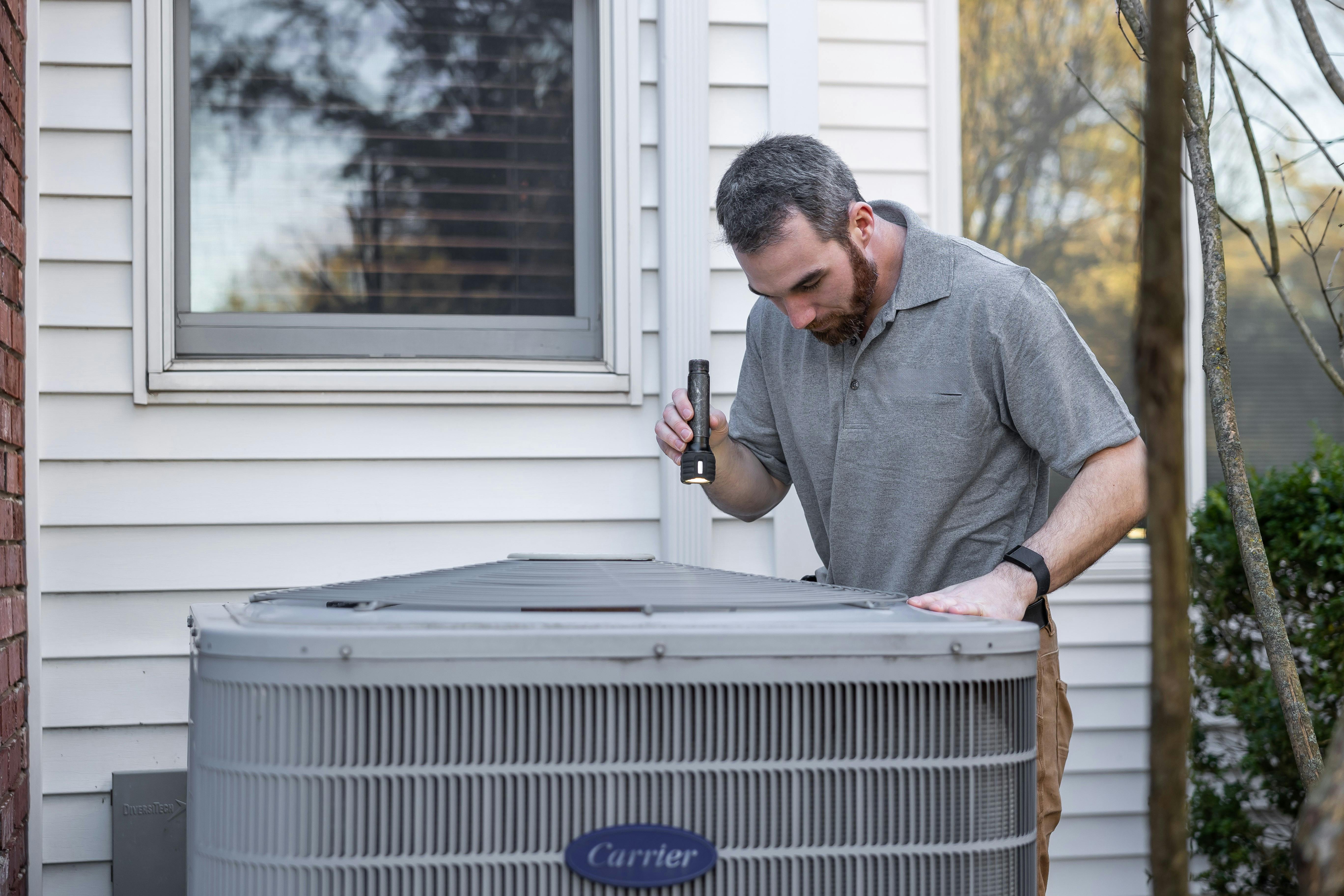 HVAC%20Maintenance Property manager doing maintenance on an HVAC system